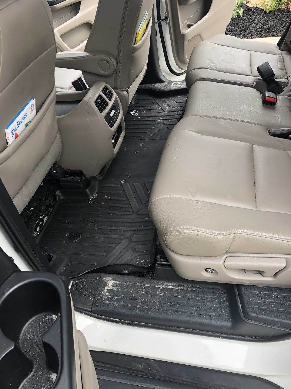 Honda Pilot backseat before an interior detail in Encinitas, sand and family wear on the seats and mats