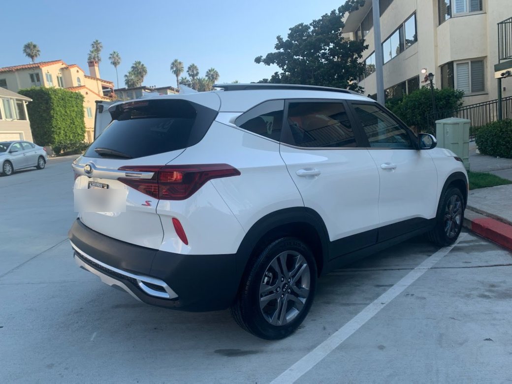 Kia SUV cleaned and gleaming in a residential driveway after a mobile detail