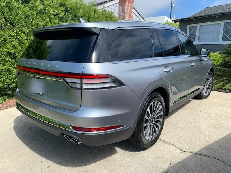 Silver Lincoln SUV gleaming in a driveway after a mobile detail