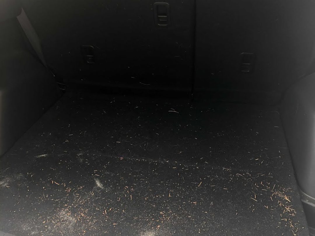 Mazda CX-5 cargo area before cleaning, covered in dirt and debris