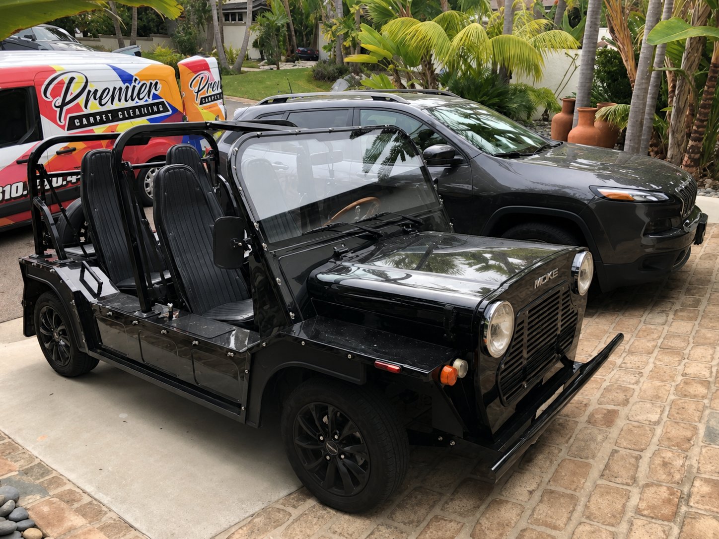 Black Moke electric beach cruiser freshly washed in a home driveway