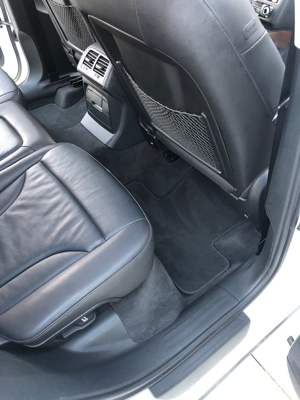 Same rear footwell carpet completely clean after pet hair removal in San Diego