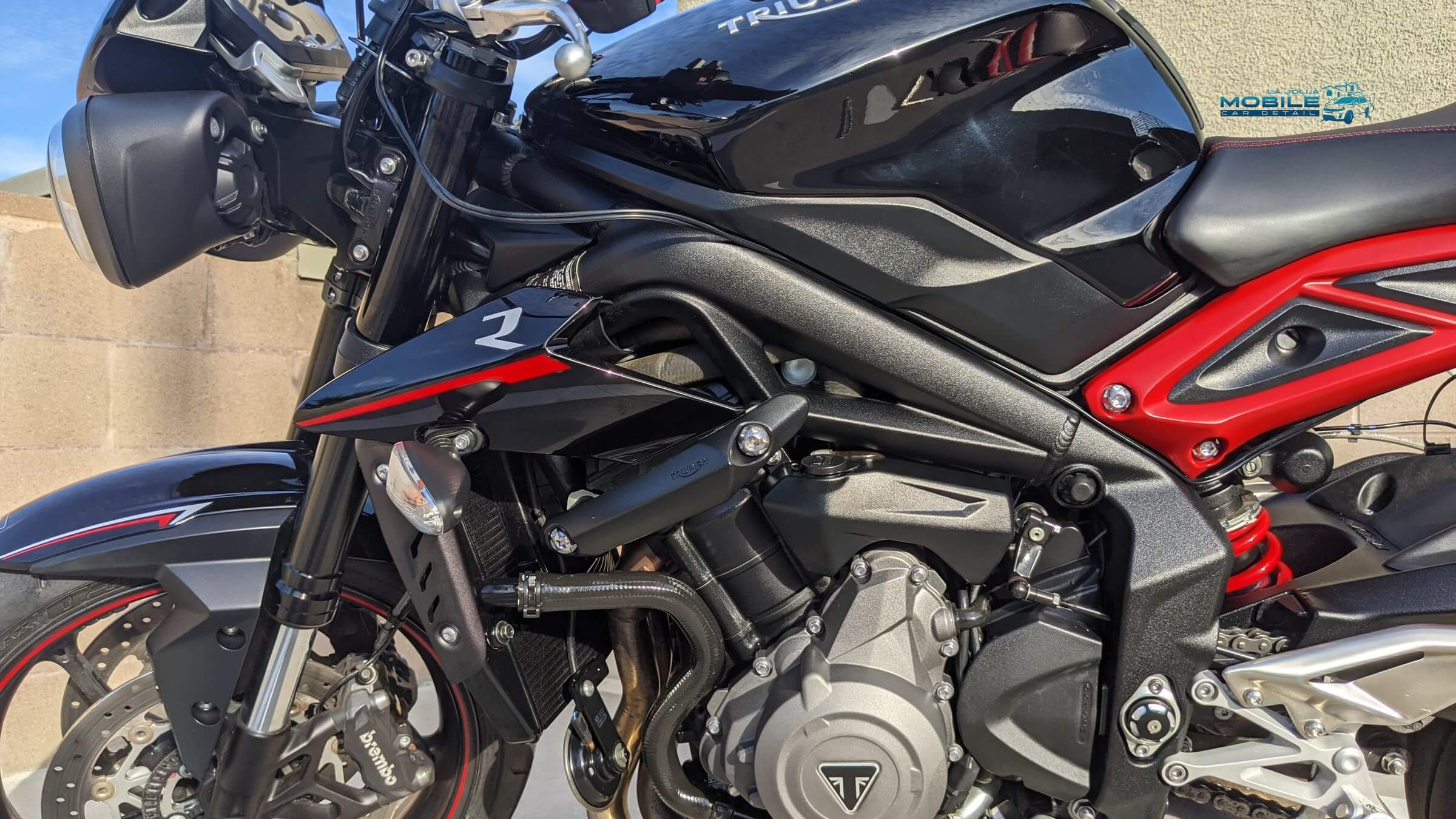 Ceramic coating on Triumph motorcycle in San Diego - professional paint protection for all vehicles