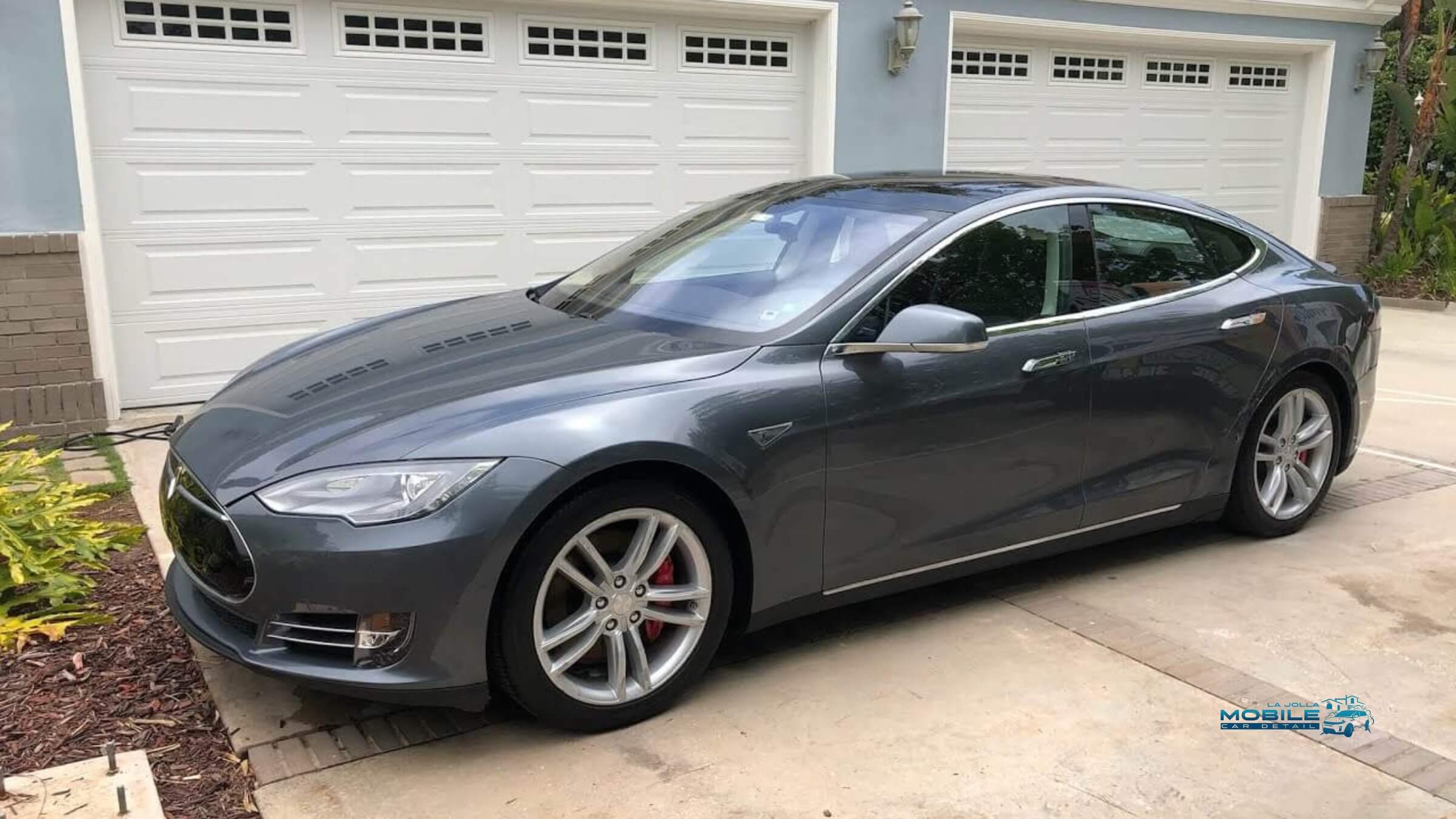 Professional car detailing for a Tesla sedan in San Diego, showcasing the exterior finish of a standard detail package.